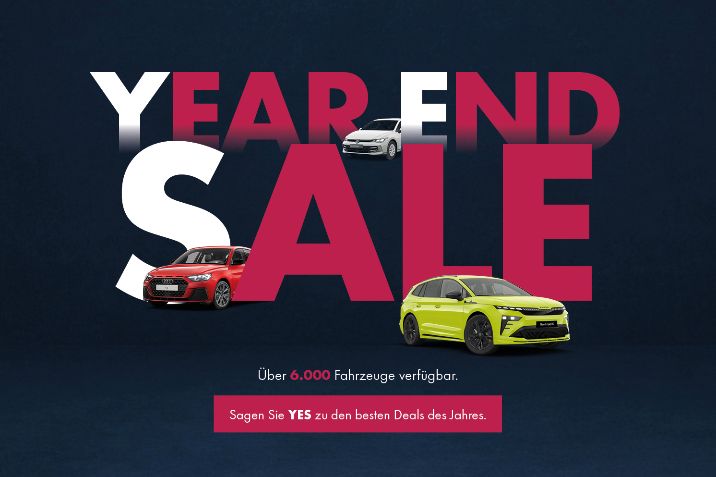 Grafik mit großem Schriftzug „Year End Sale“ und mehreren Autos davor, sowie Hinweisen auf über 6.000 verfügbare Fahrzeuge.